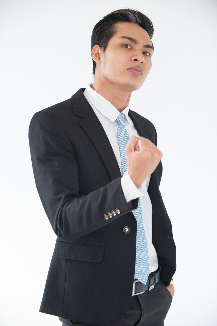 aggressive-young-businessman-threatening-with-fist_1262-4668